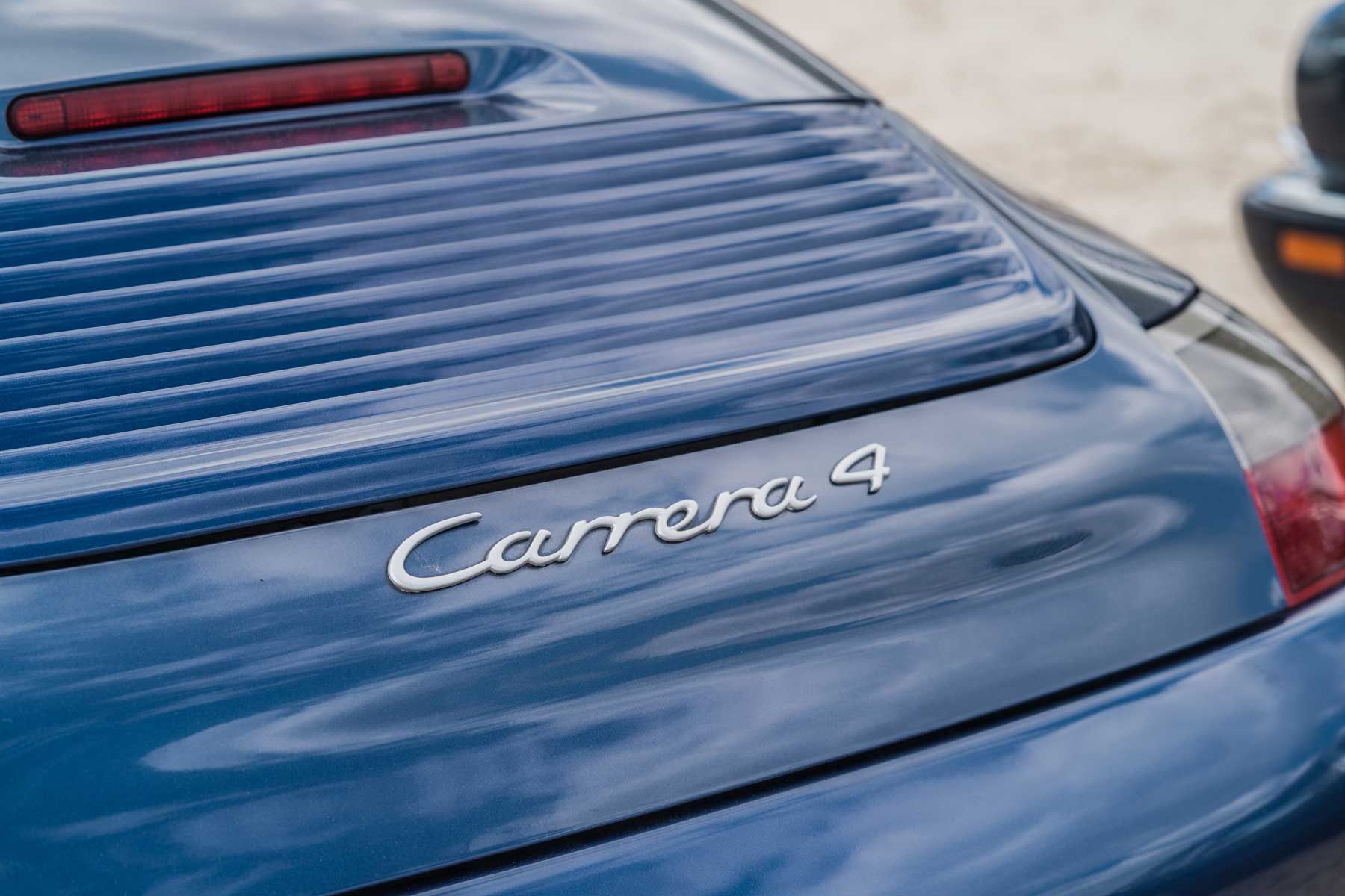 Rear badge of a blue Porsche 911 Carrera 4