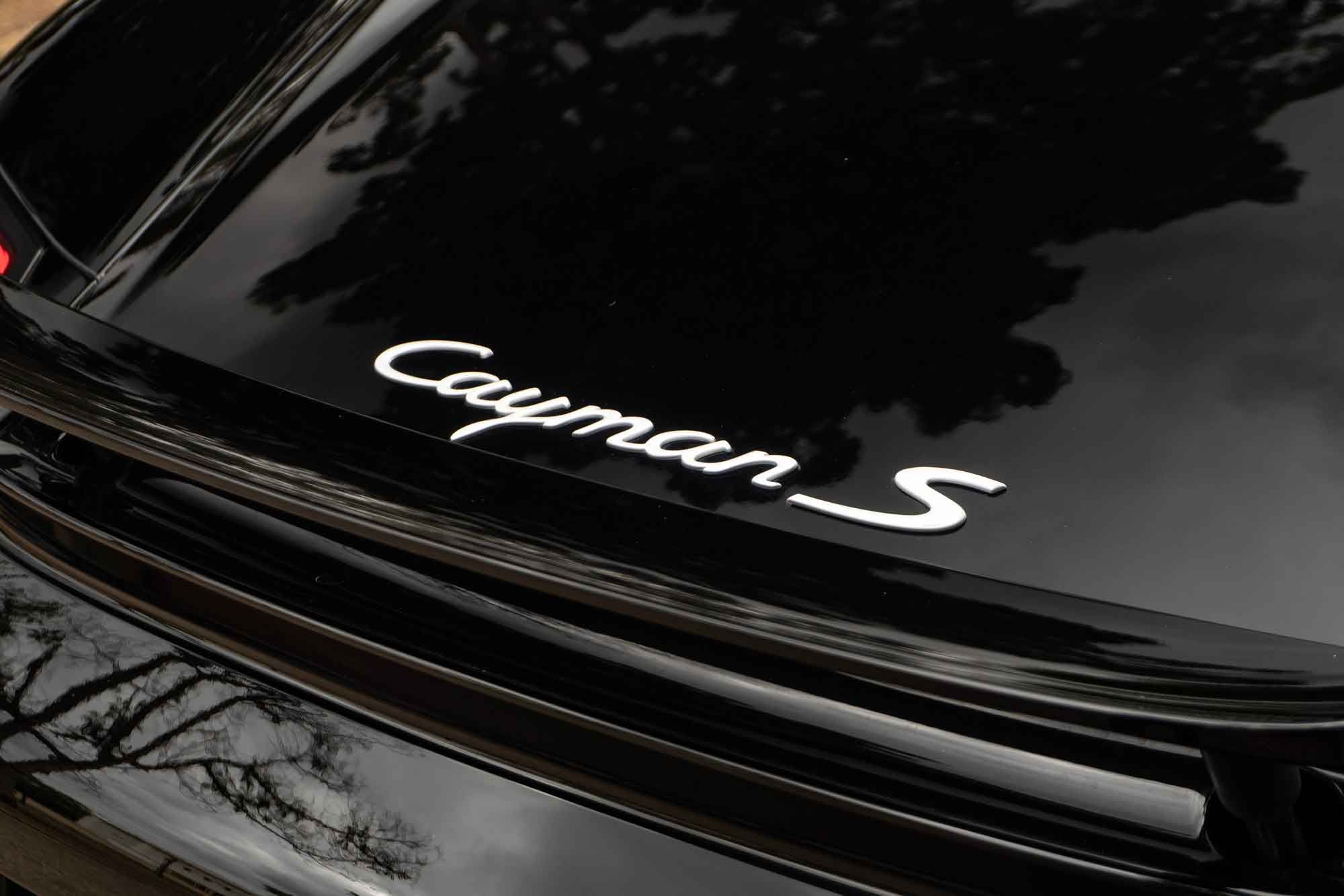 Cayman S badge on a black Porsche 987