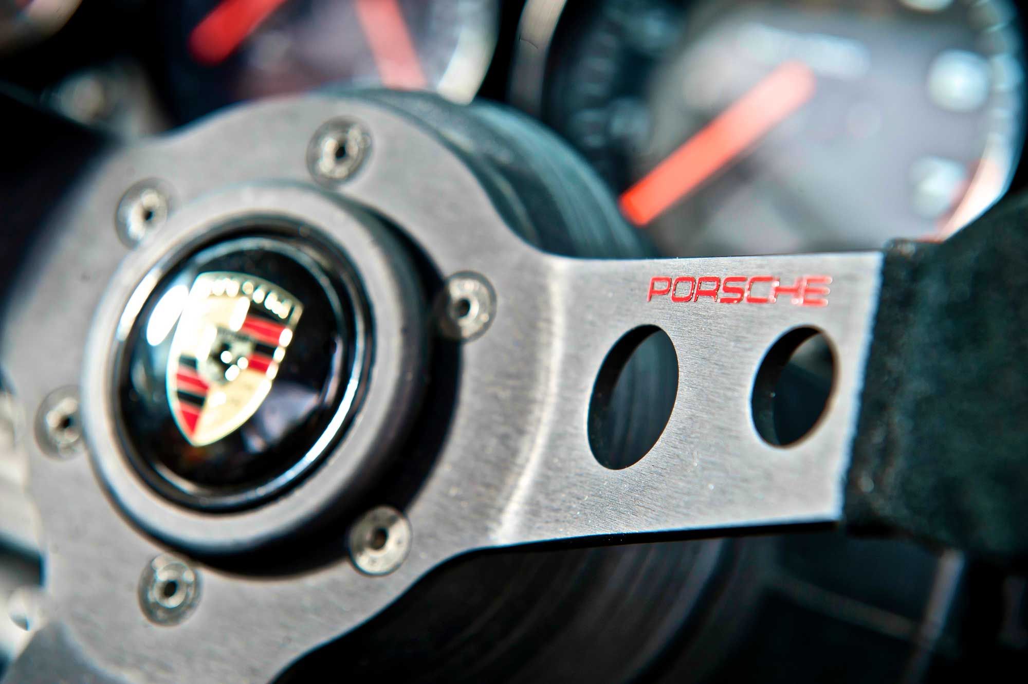 Drilled-spoke Porsche steering wheel with crest horn push