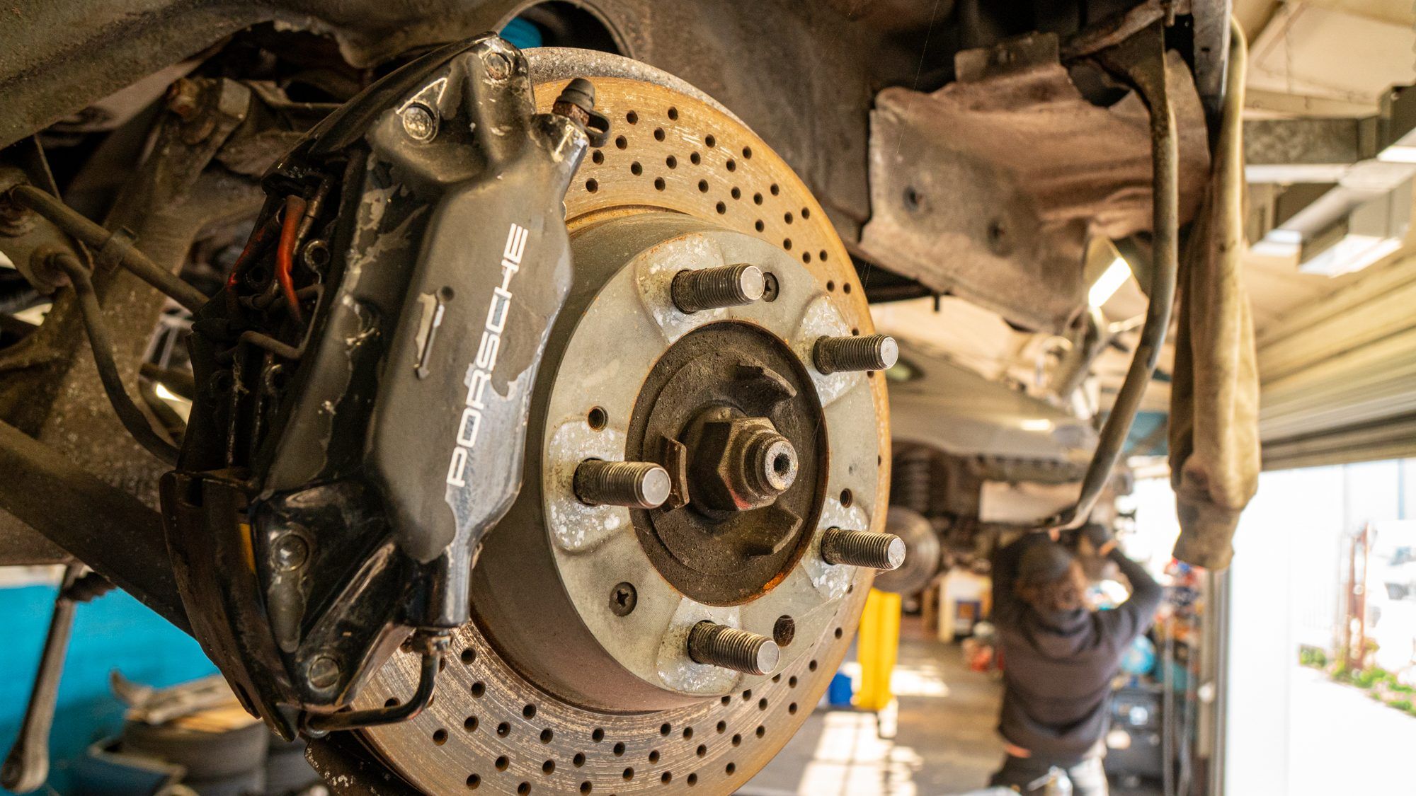 Porsche brake caliper and drilled disc with the wheel removed