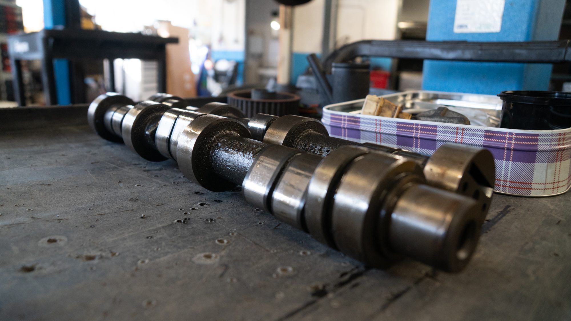 Porsche camshafts laid out on a workbench