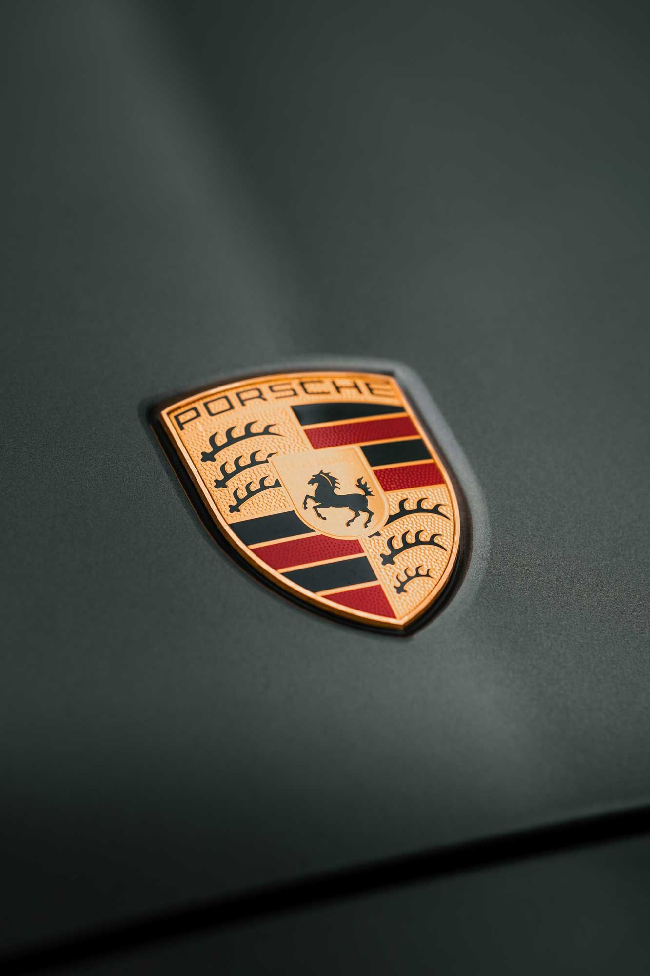 Porsche crest on a grey bonnet