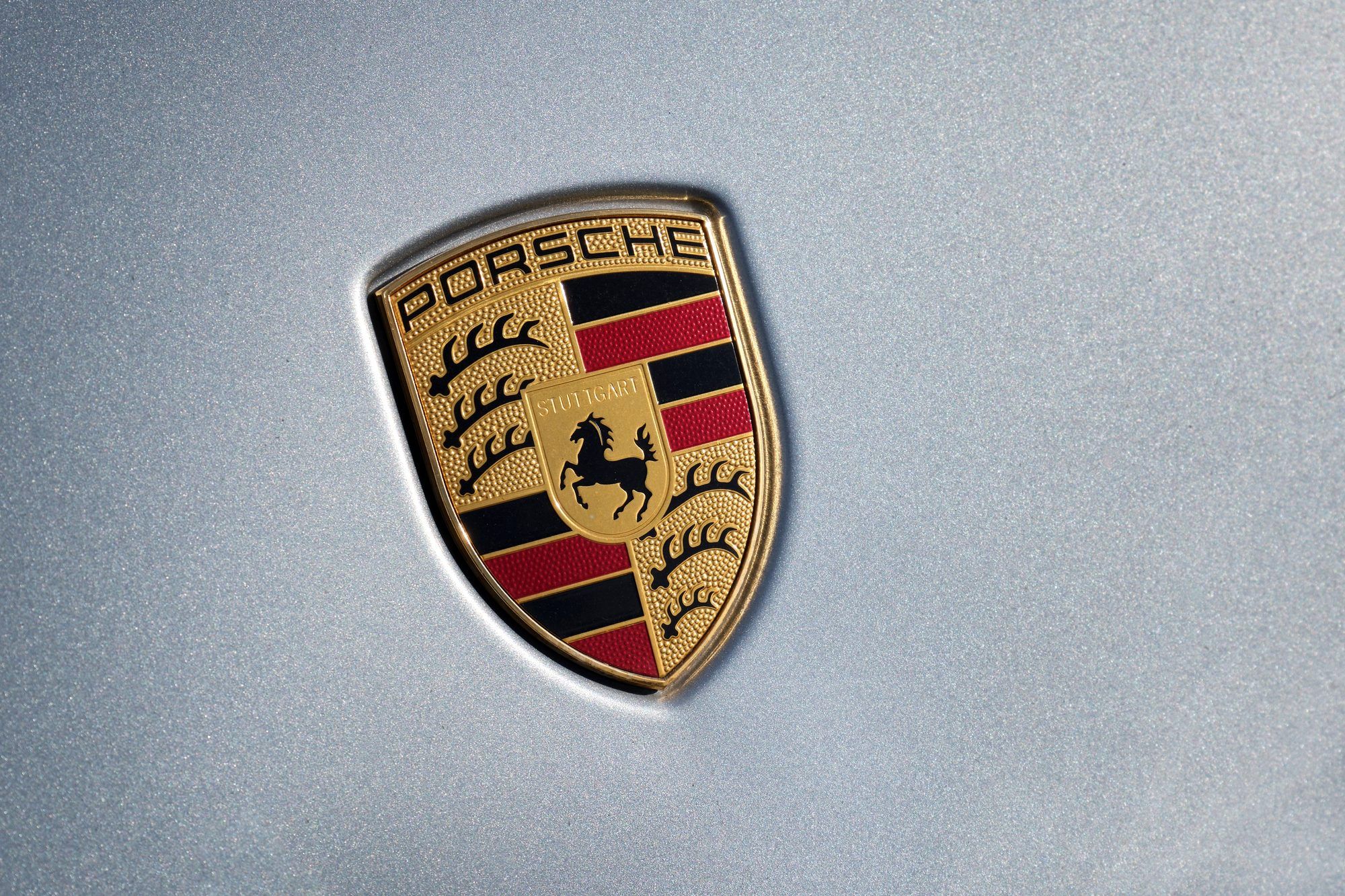 Porsche crest on a silver bonnet