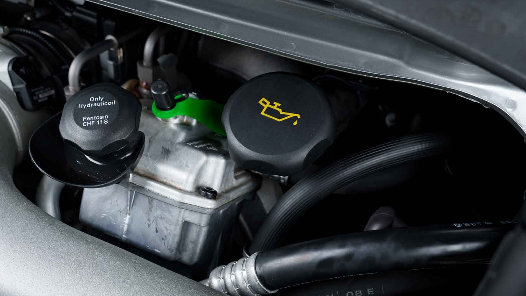 Fluid reservoirs and oil filler cap in a Porsche engine bay