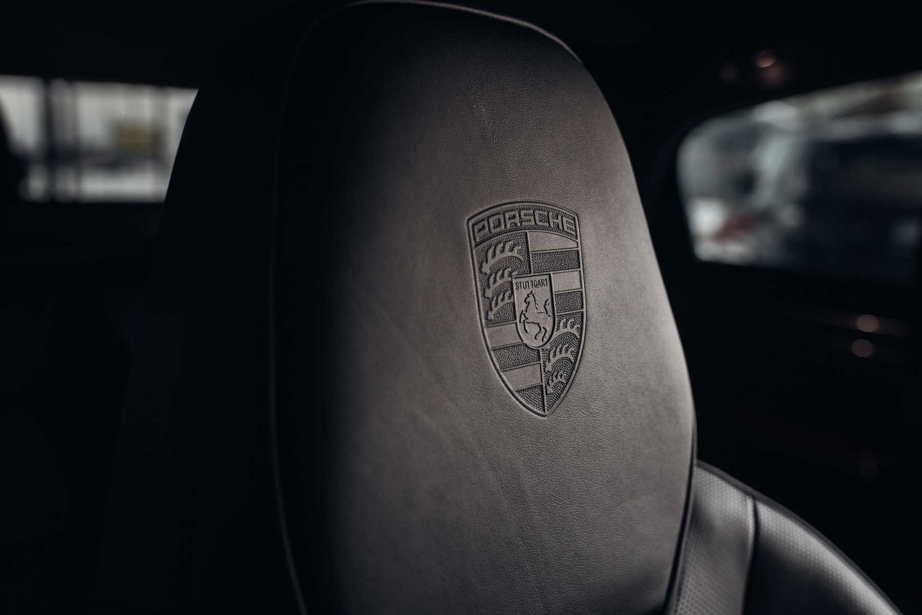 Porsche crest embossed in a seat headrest