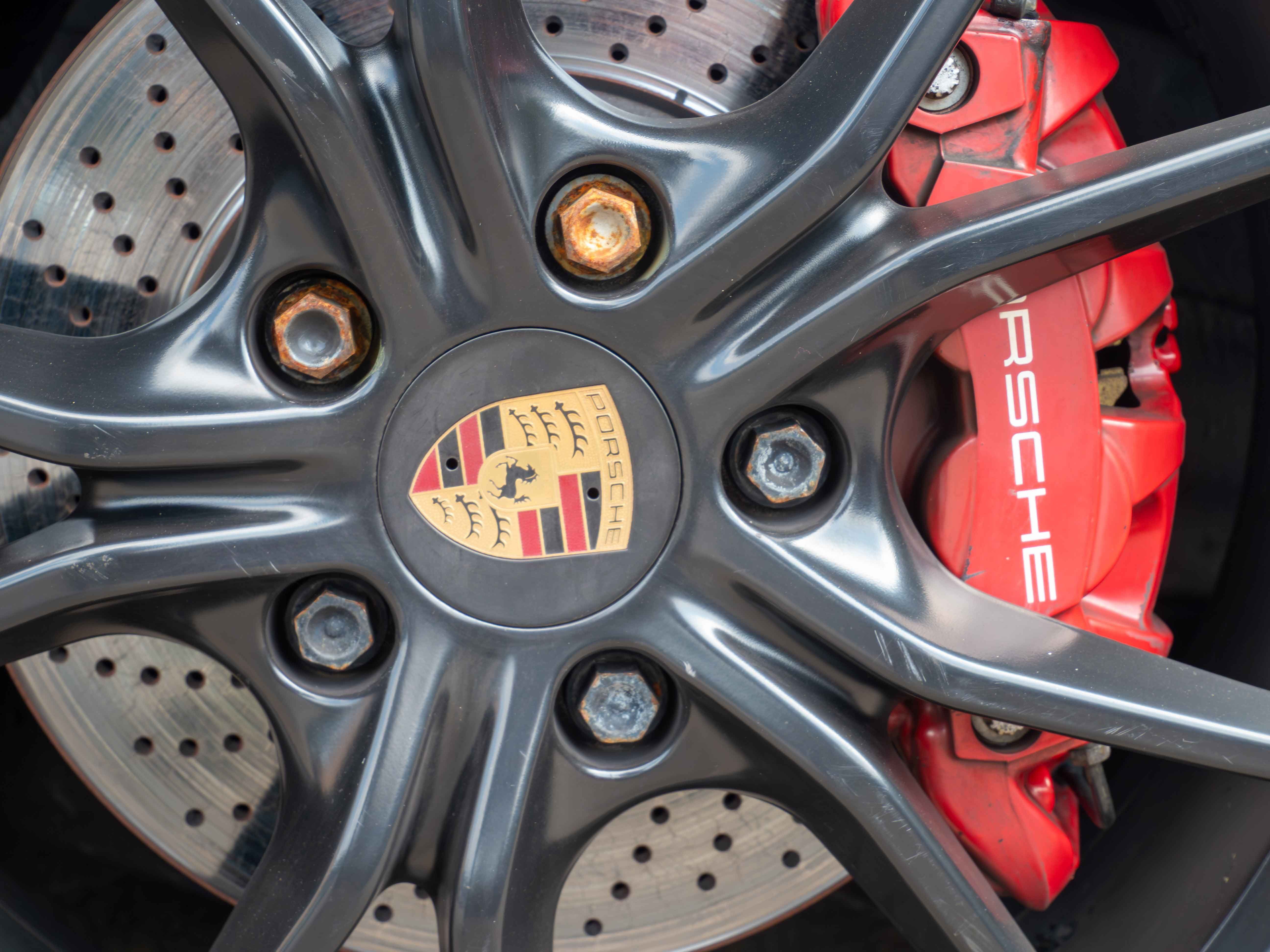 Close-up of a Porsche wheel and red brake caliper