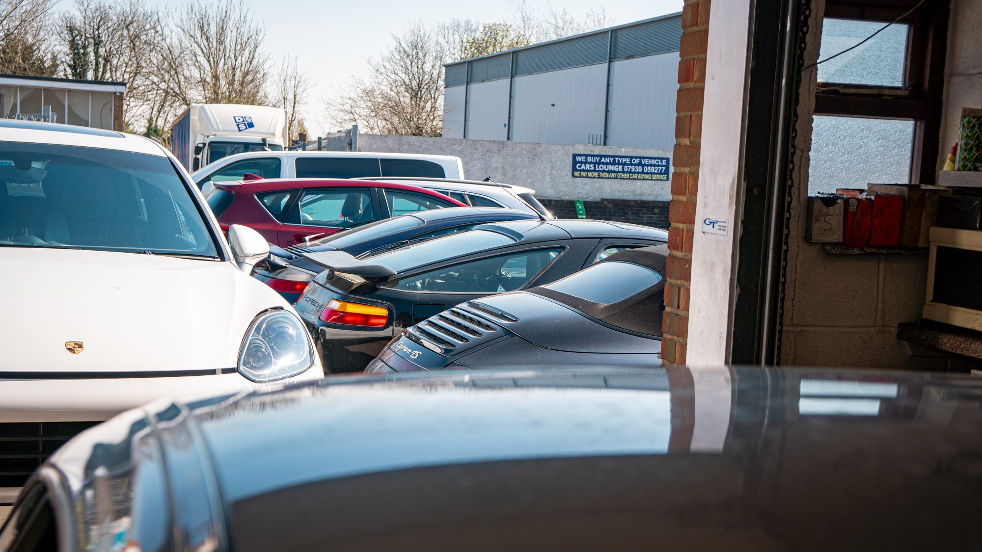 Porsches parked at the workshop