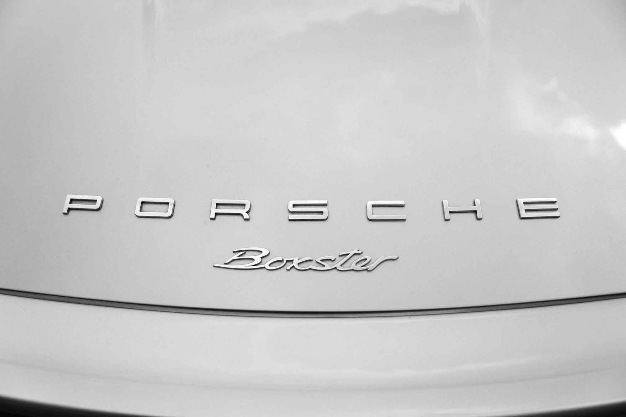 Rear lettering of a silver Porsche Boxster