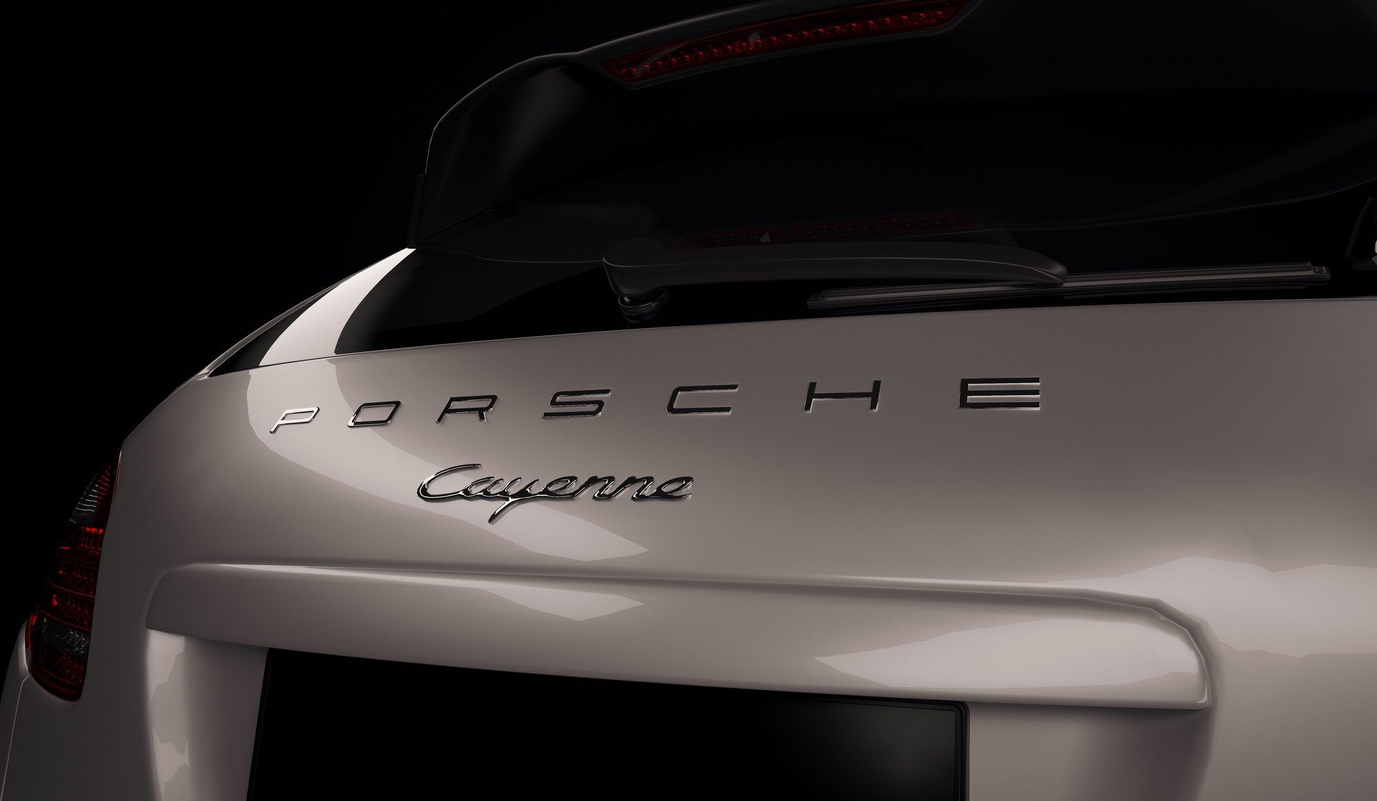 Porsche and Cayenne lettering on the tailgate of a silver Cayenne