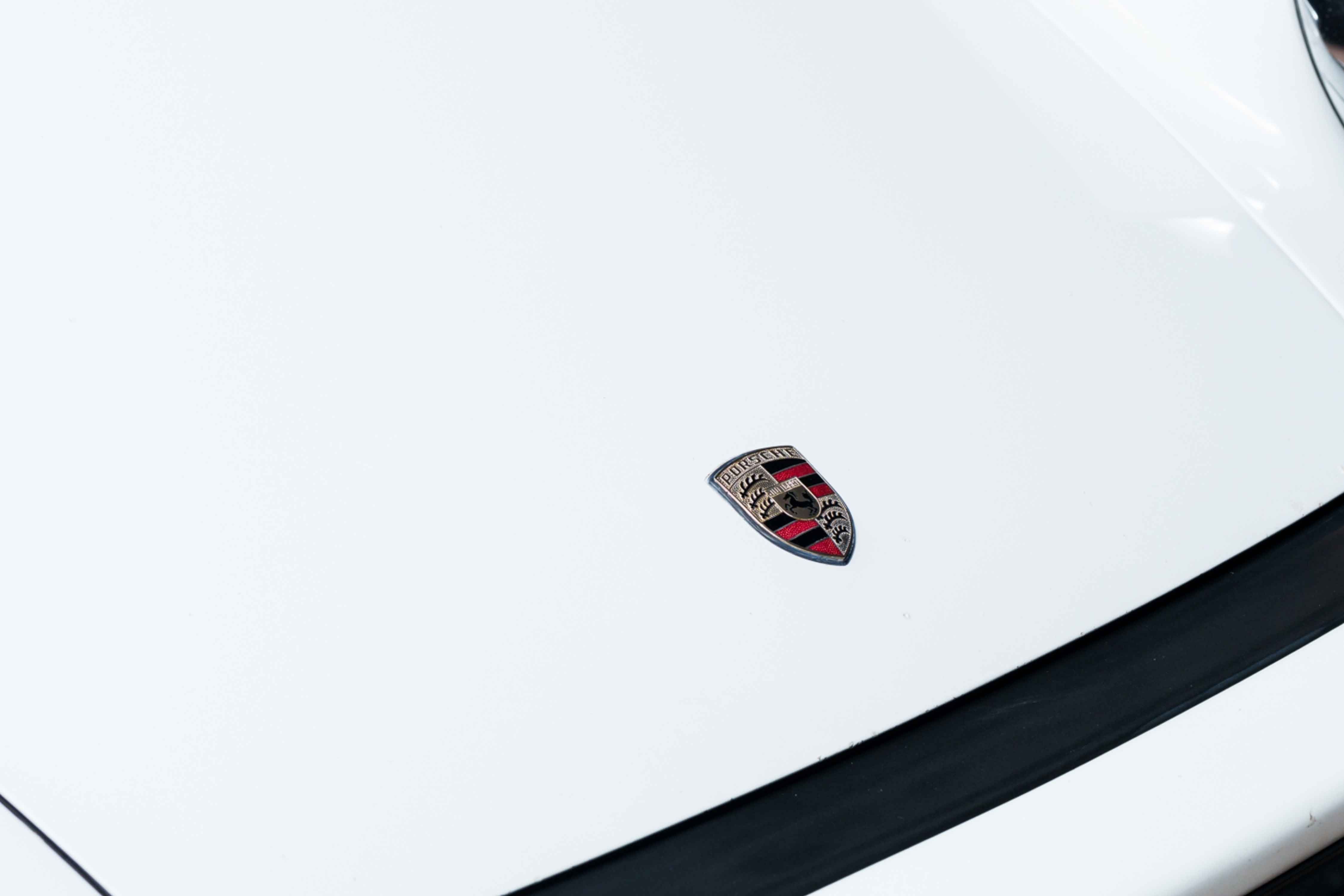 Porsche crest on a white bonnet