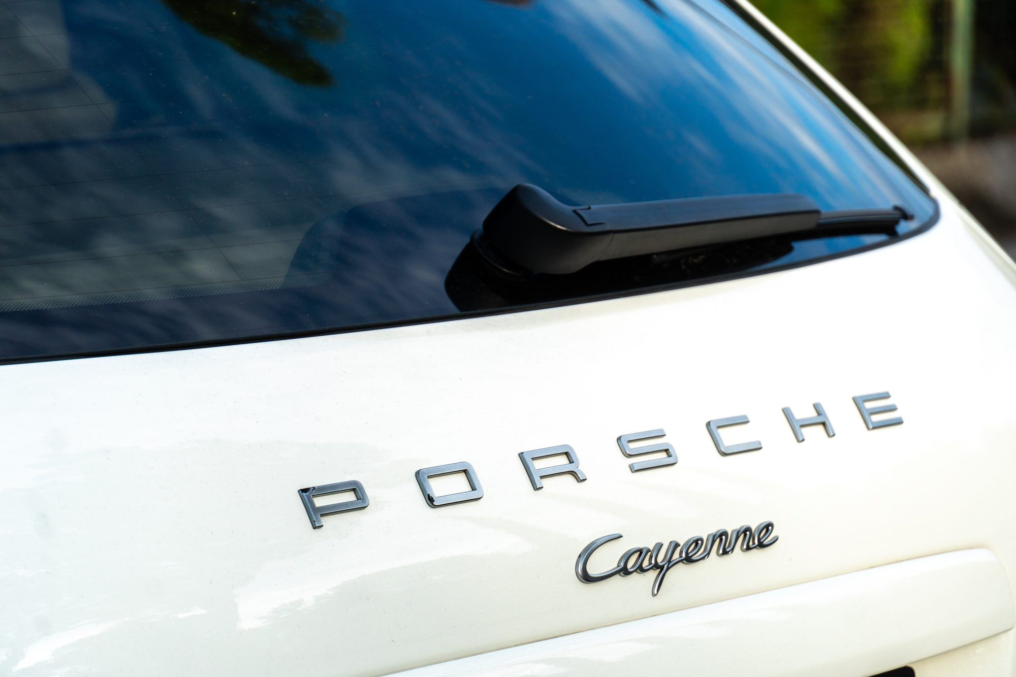 Porsche and Cayenne lettering on the tailgate of a white Cayenne