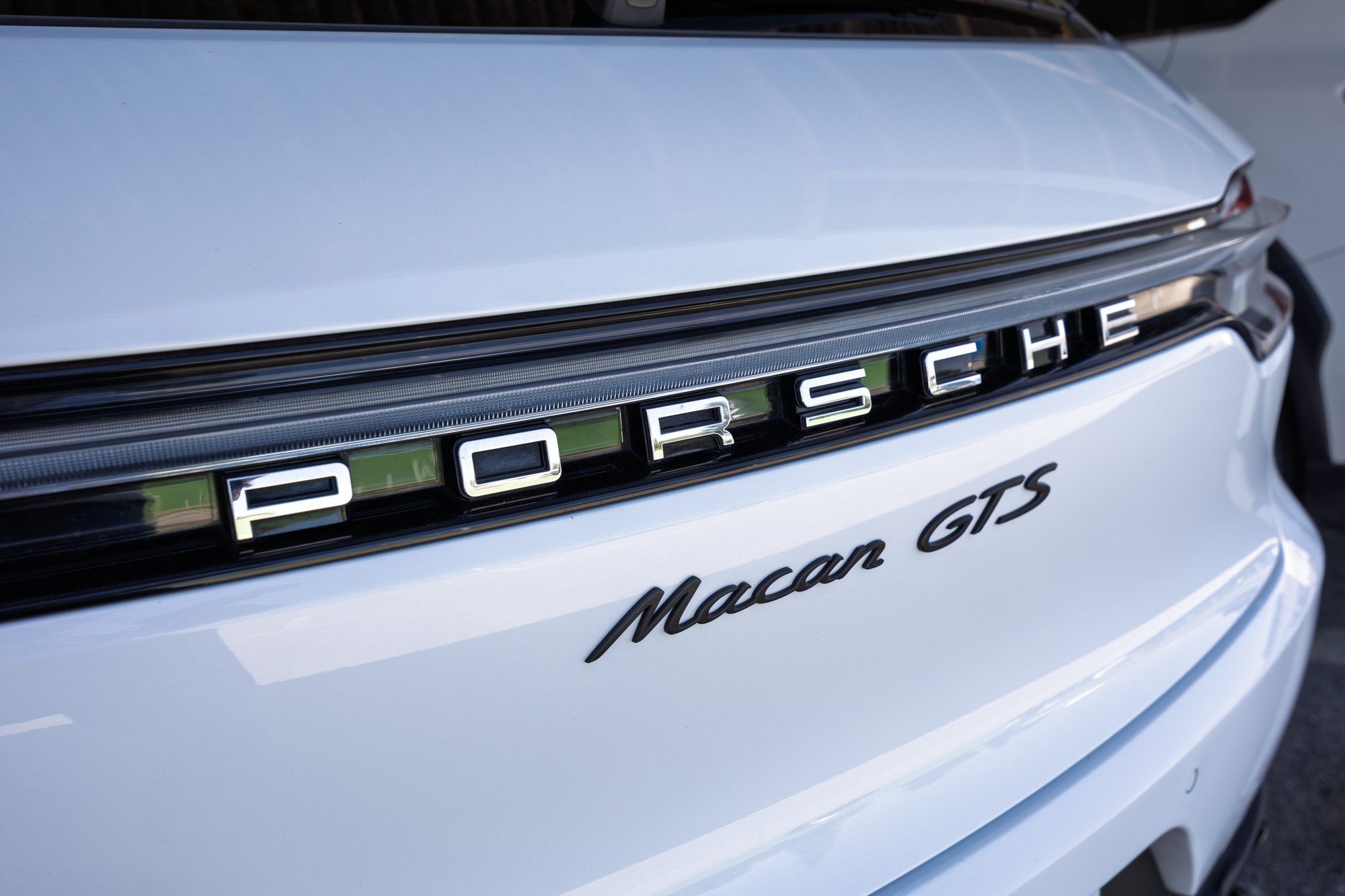 Porsche and Macan GTS lettering on a white Macan